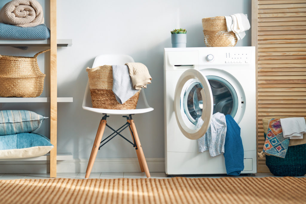 Interior of a real laundry room with a washing machine at home